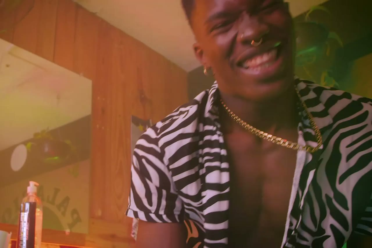 A rapper performing into a studio microphone under warm tungsten light, cinematic AI clip